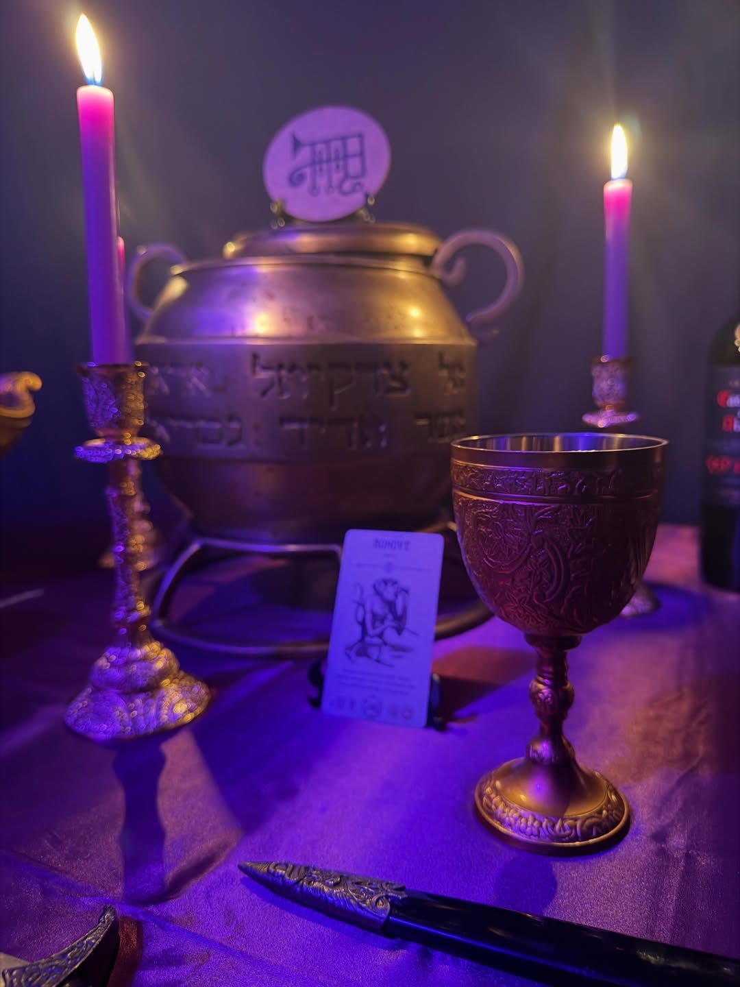 Altar em luz magenta com caldeirão e selo